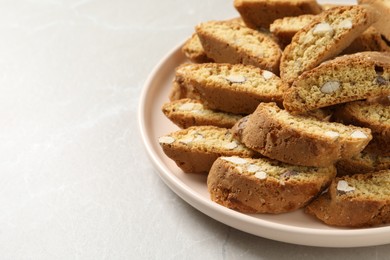 Traditional Italian almond biscuits (Cantucci) on light marble table, closeup. Space for text