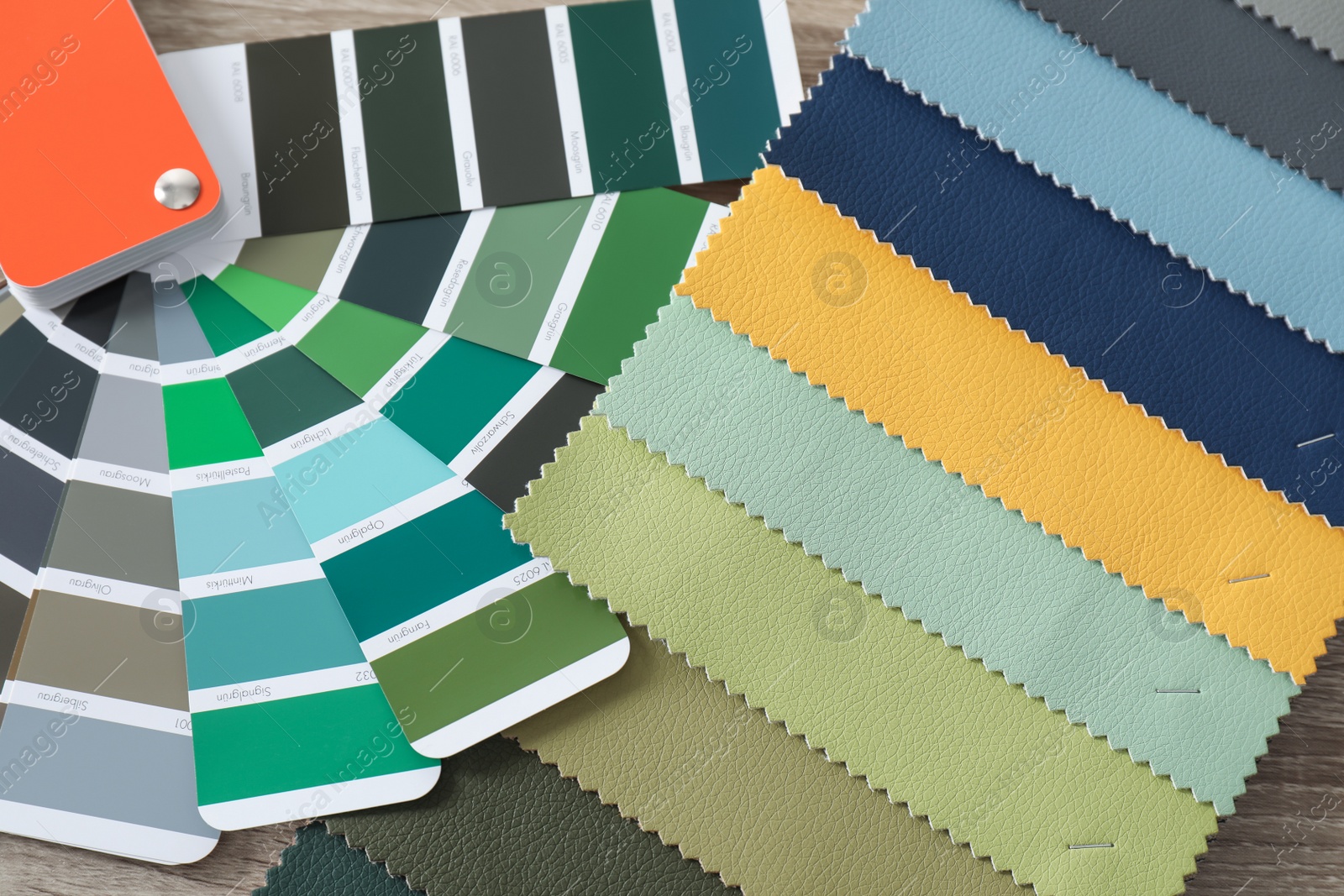 Photo of Upholstery fabric samples and color palette on table. Interior design