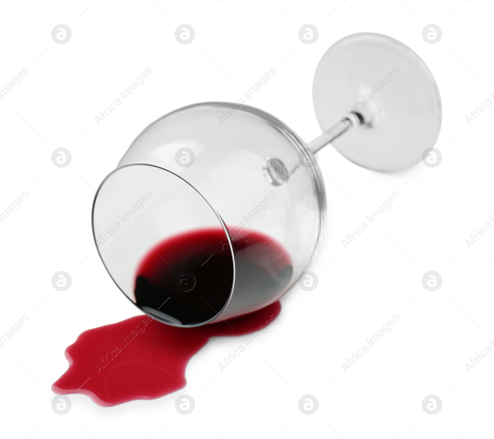 Photo of Overturned glass and spilled wine on white background