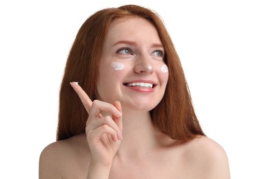 Smiling woman with freckles and cream on her face against white background, closeup