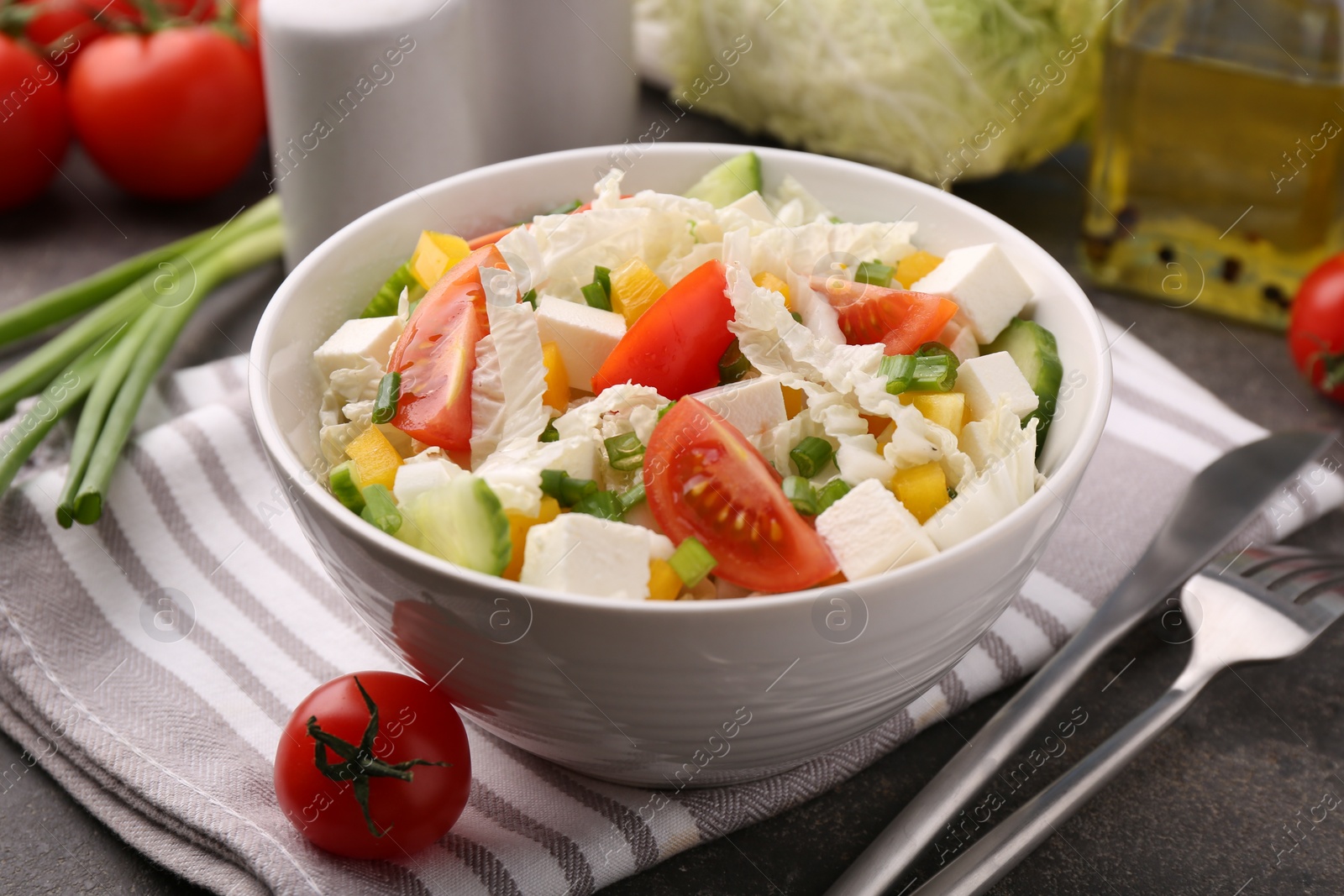 Photo of Tasty salad with Chinese cabbage served on grey table, closeup