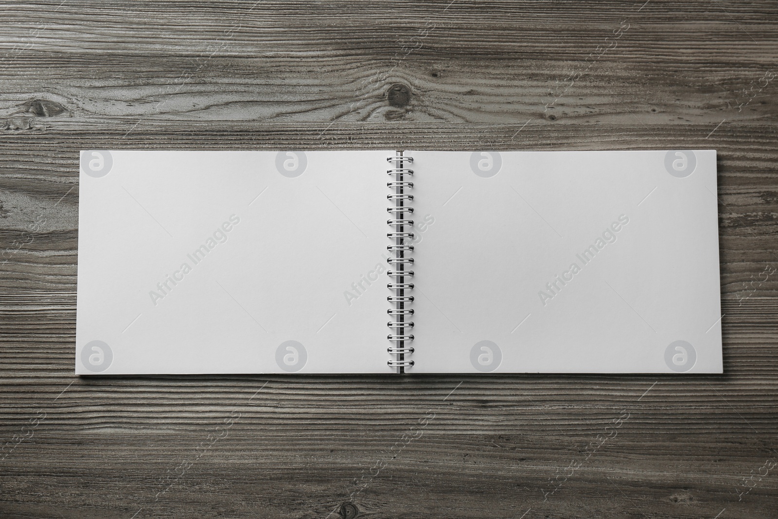 Photo of Blank paper brochure on wooden table, top view. Mockup for design