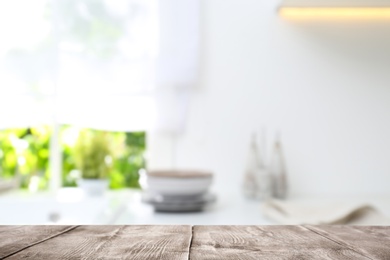 Image of Wooden table in light kitchen. Space for design