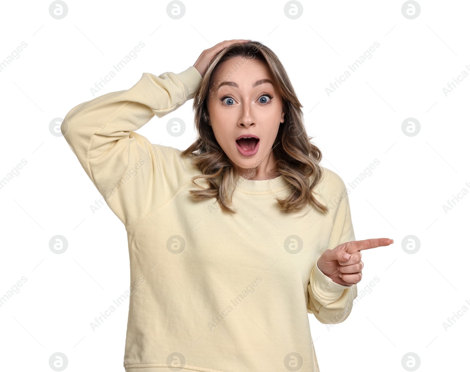 Photo of Portrait of surprised woman pointing at something on white background
