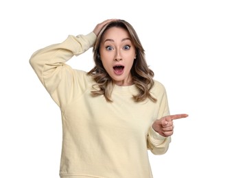 Portrait of surprised woman pointing at something on white background