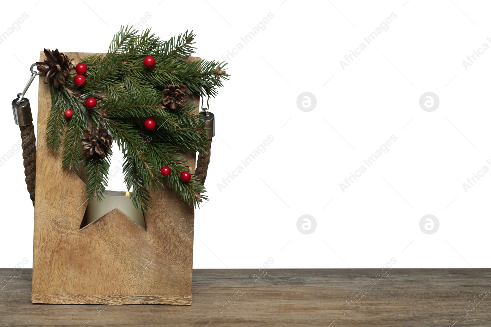 Photo of Wooden Christmas lantern with burning candle on table, space for text