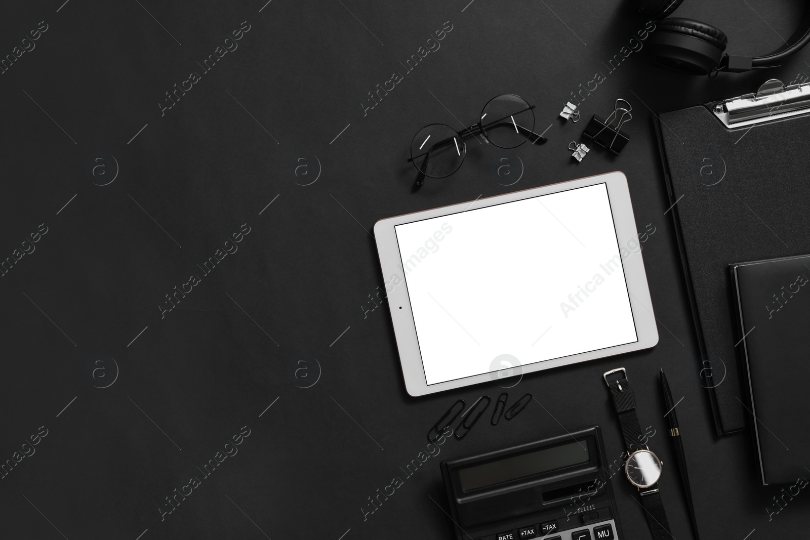 Photo of Flat lay composition with modern tablet on black background. Space for text