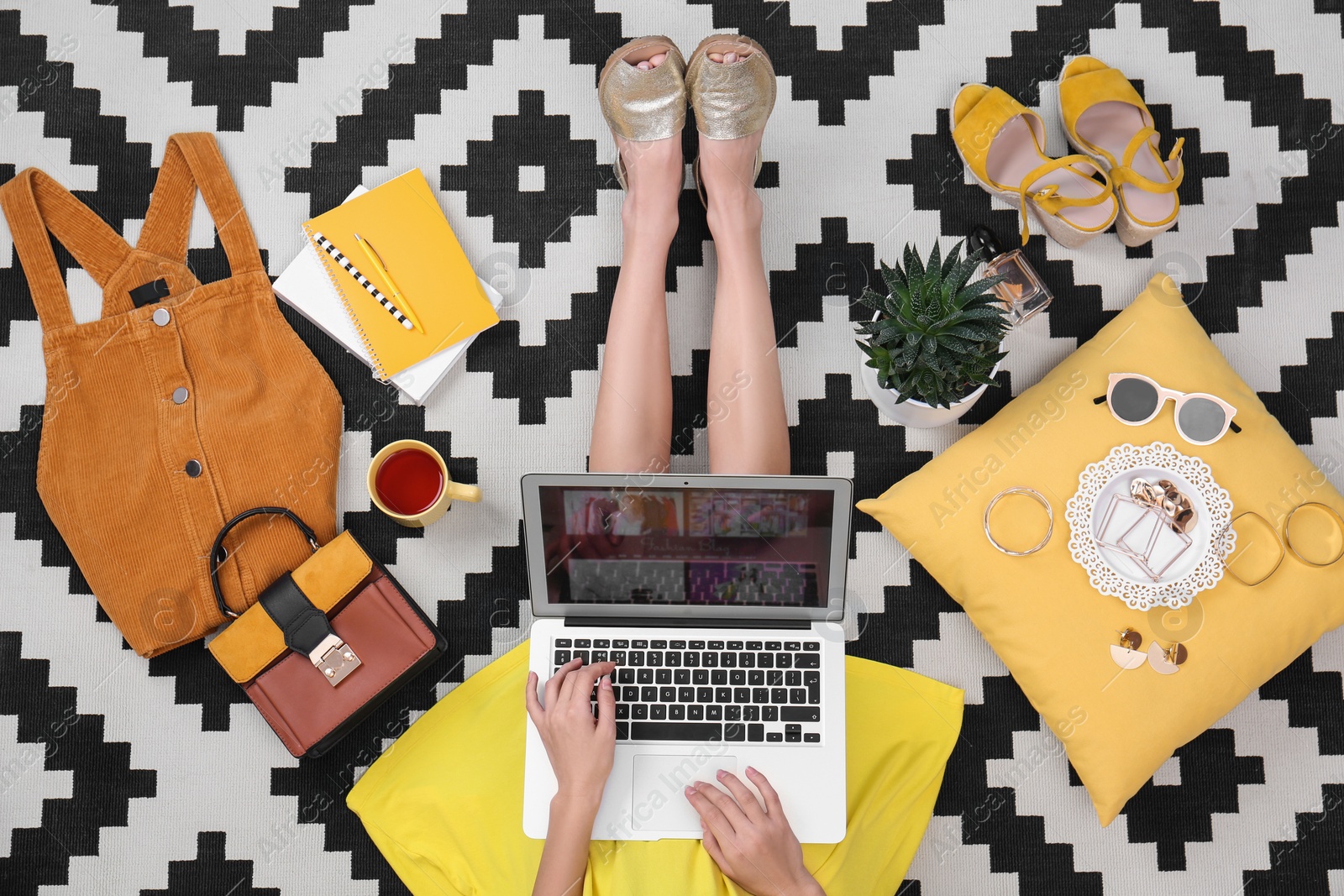 Photo of Fashion blogger with laptop sitting on floor, top view