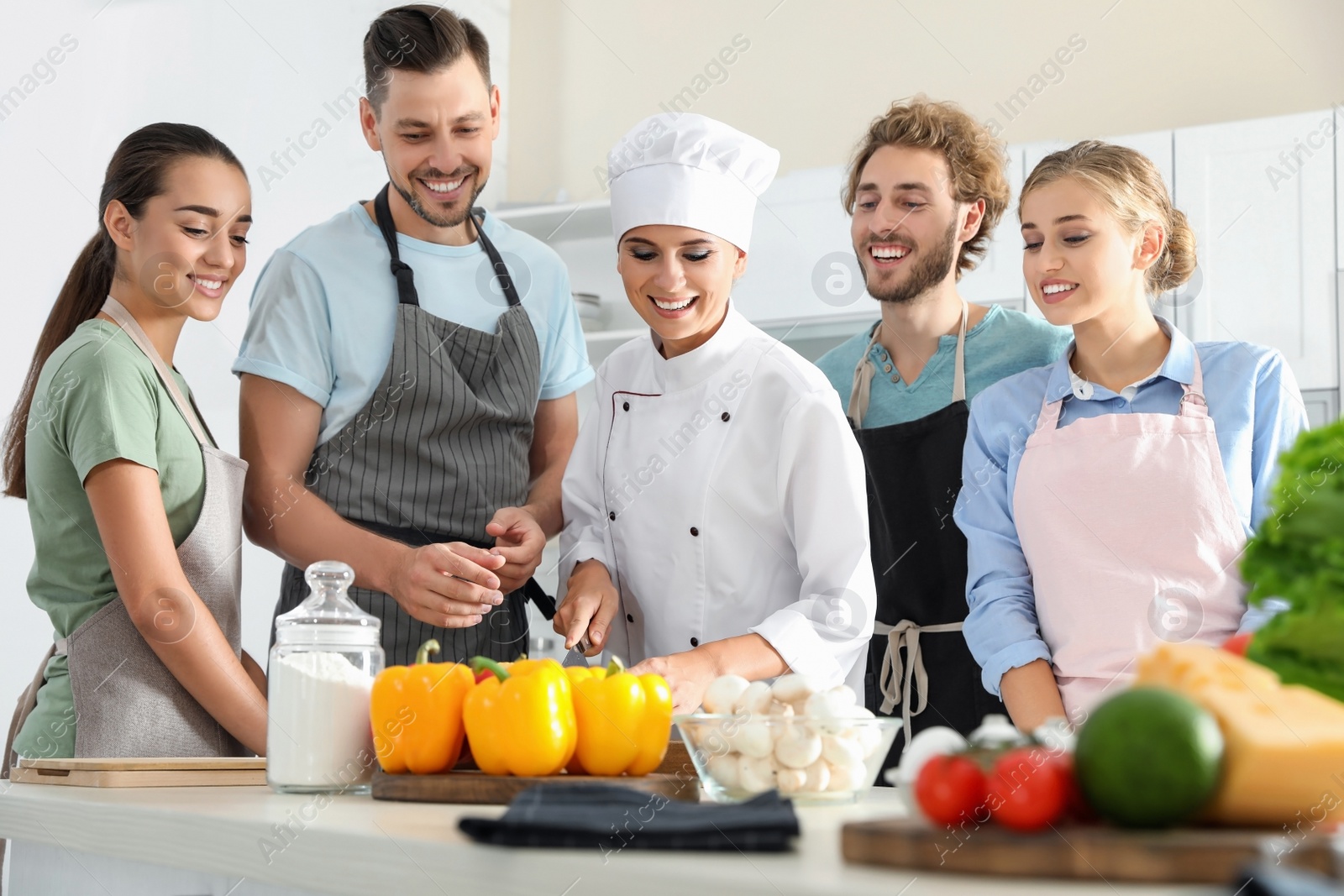 Photo of Group of people and female chef at cooking classes