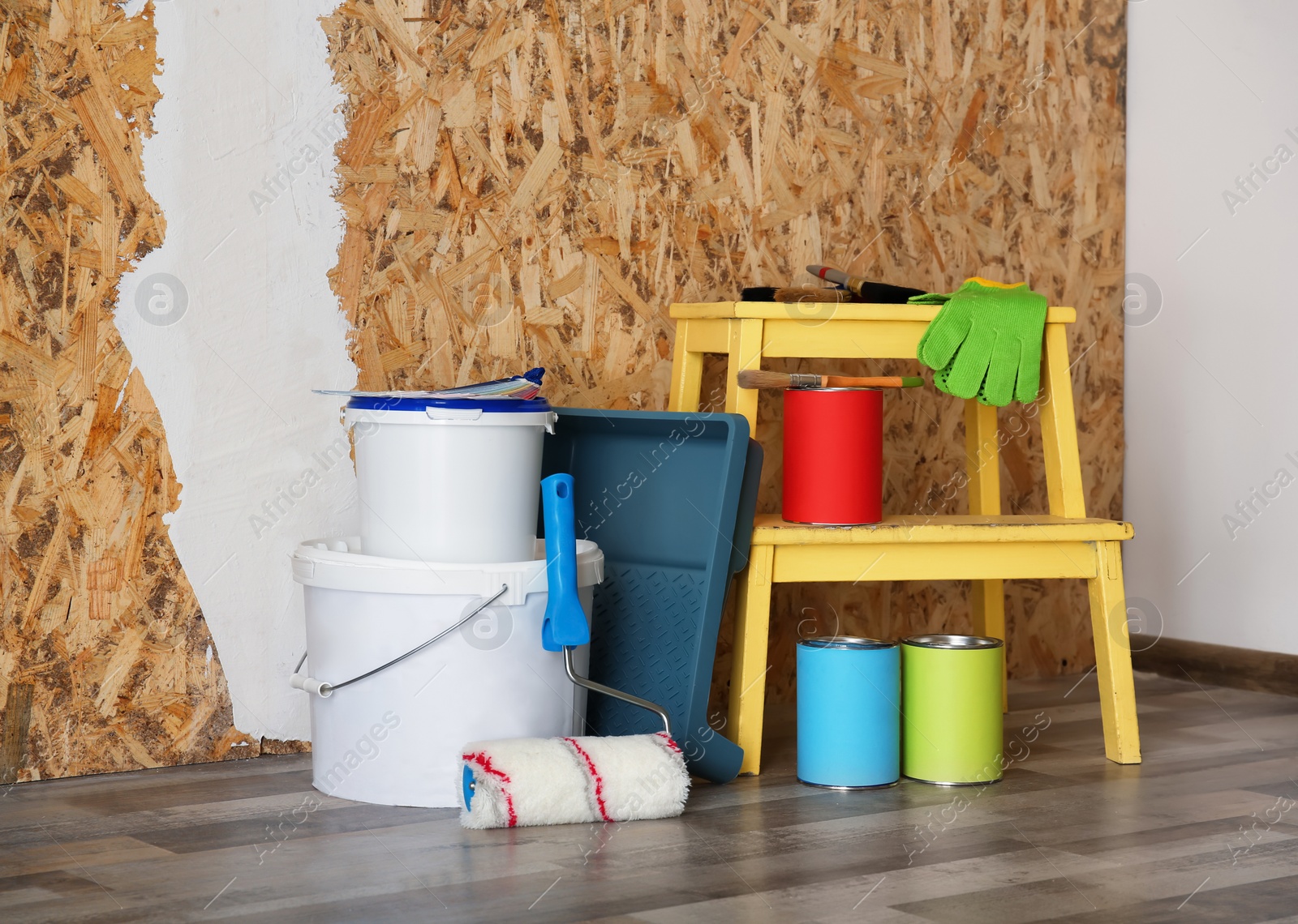 Photo of Paint and decorator's tools near wall