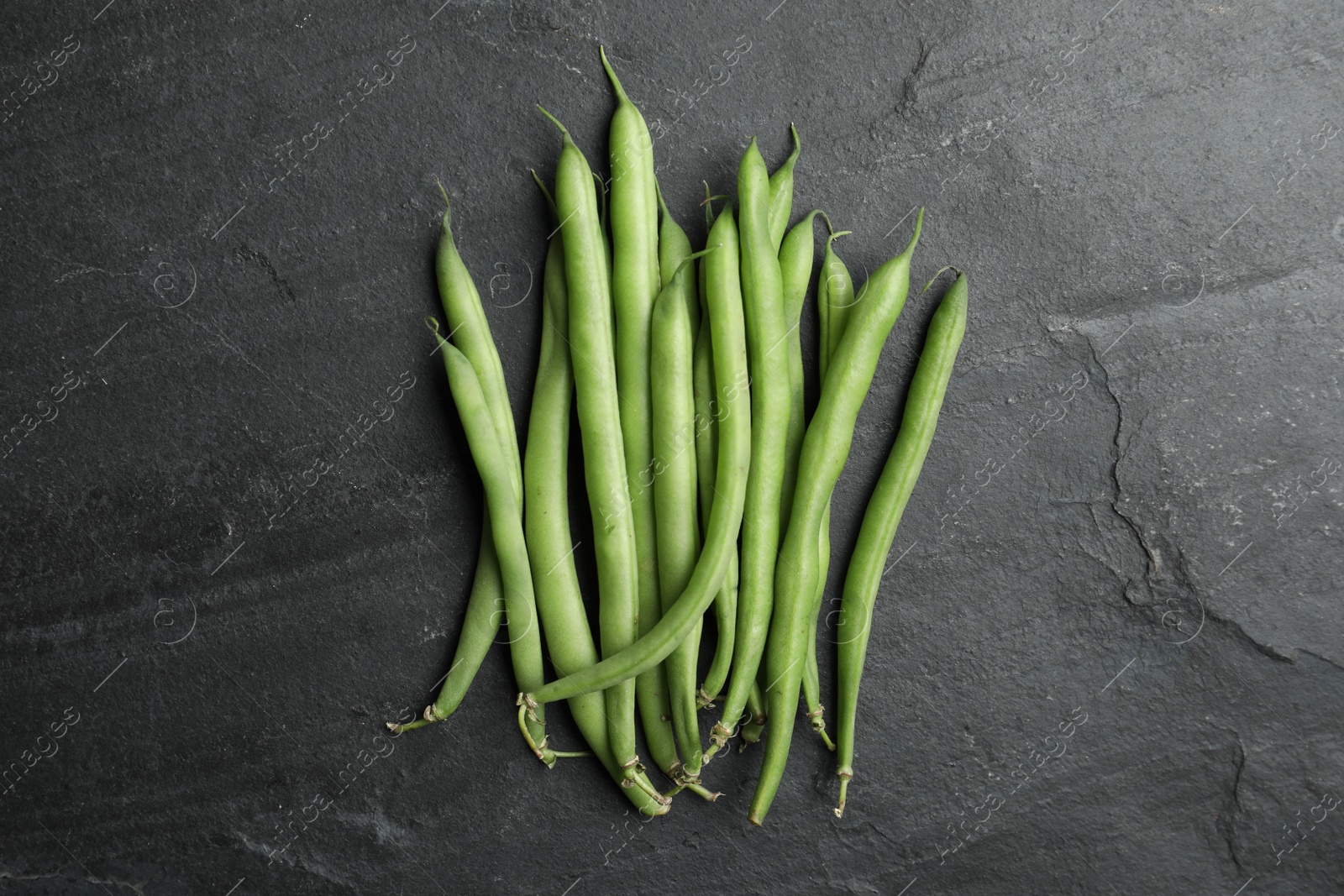 Photo of Fresh green beans on black table, flat lay