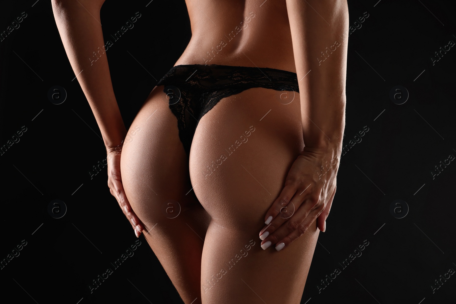 Photo of Woman in sexy panties on black background, closeup