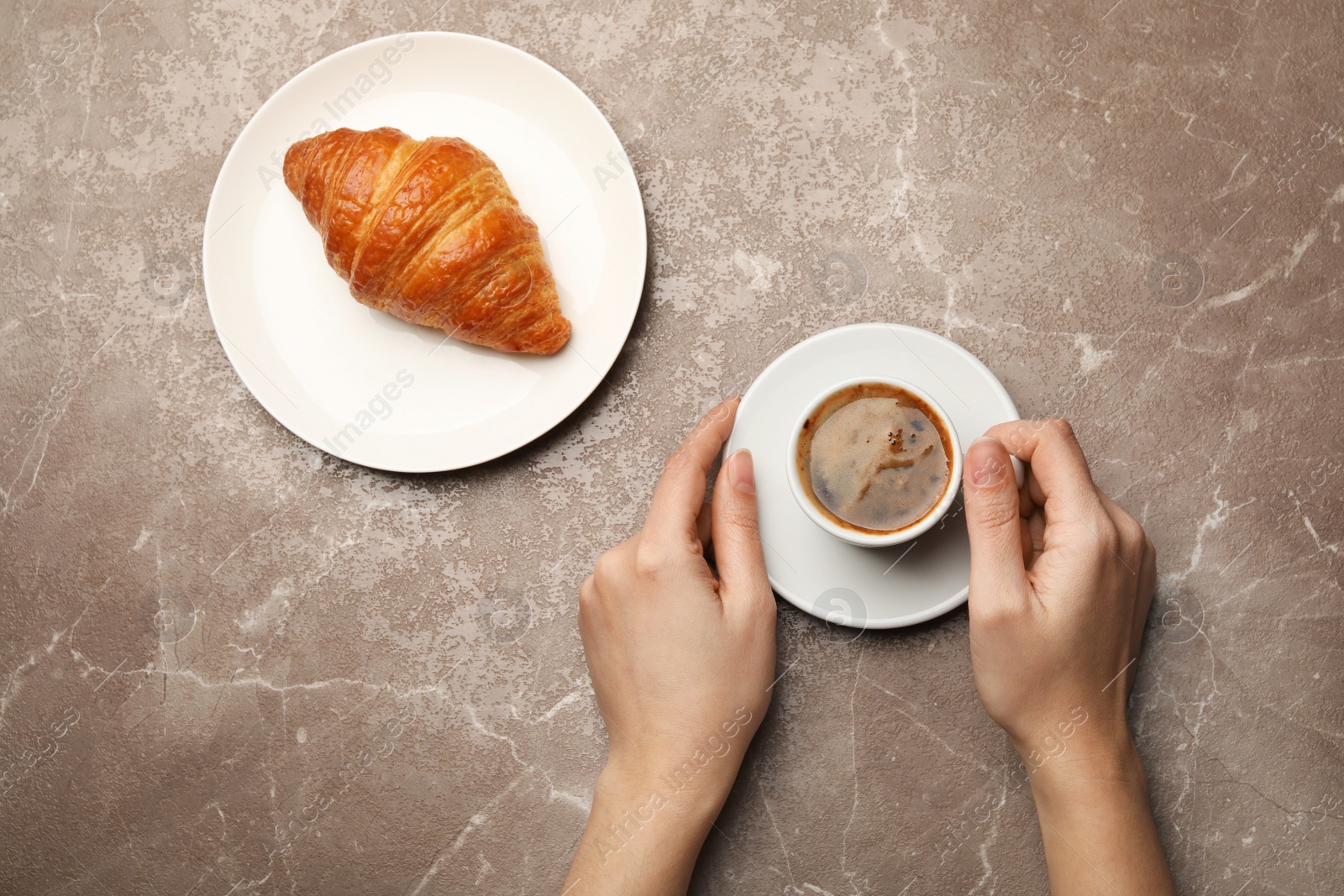 Photo of Woman with cup of coffee and croissant on color background, flat lay
