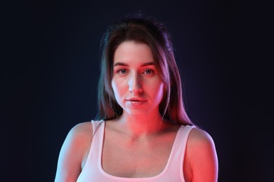 Portrait of beautiful young woman on color background