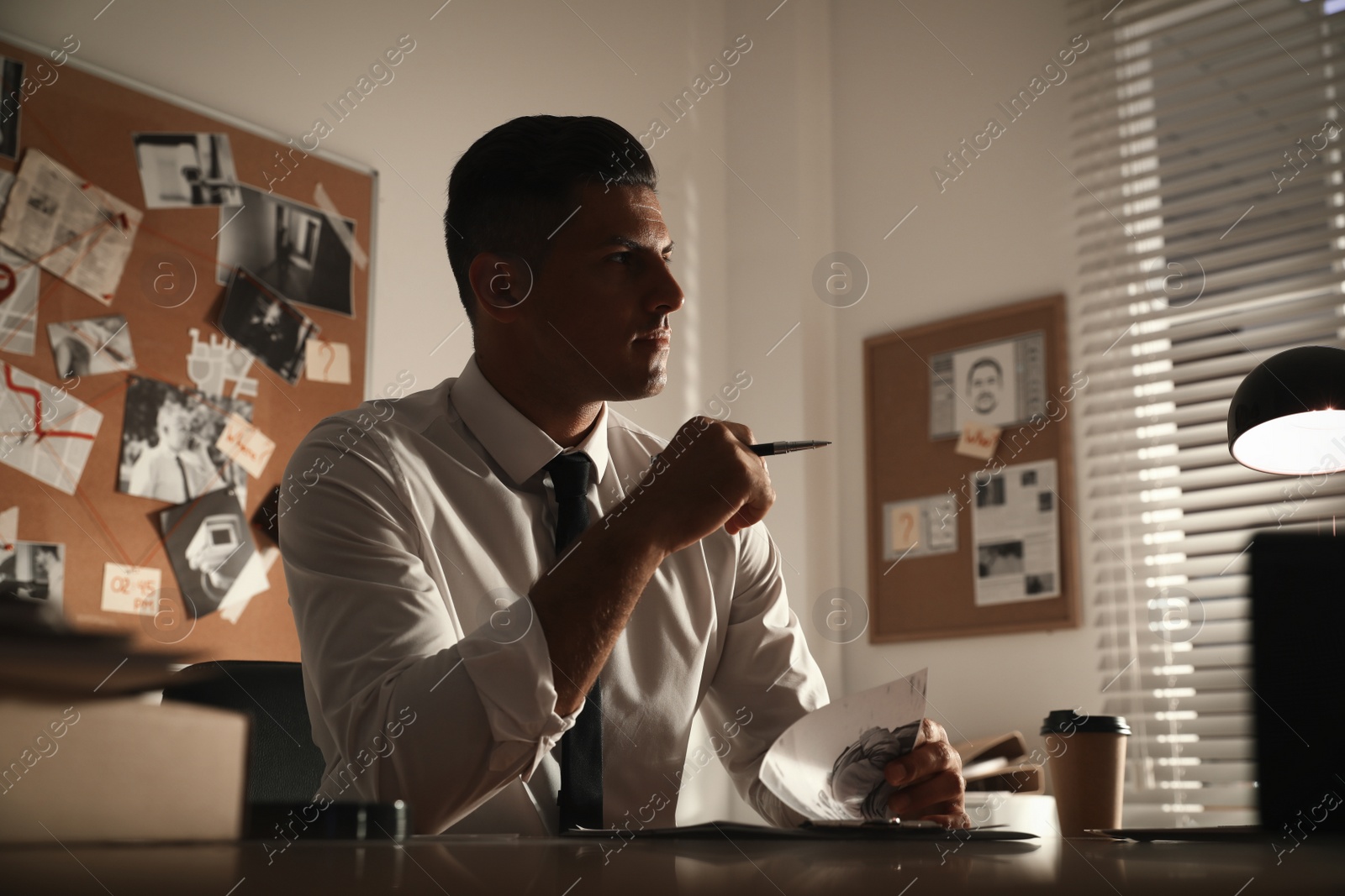 Photo of Detective working at desk in his office