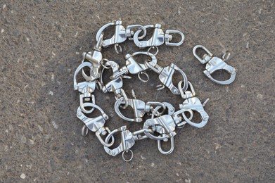 Climbing rope with carabiners on asphalt, top view