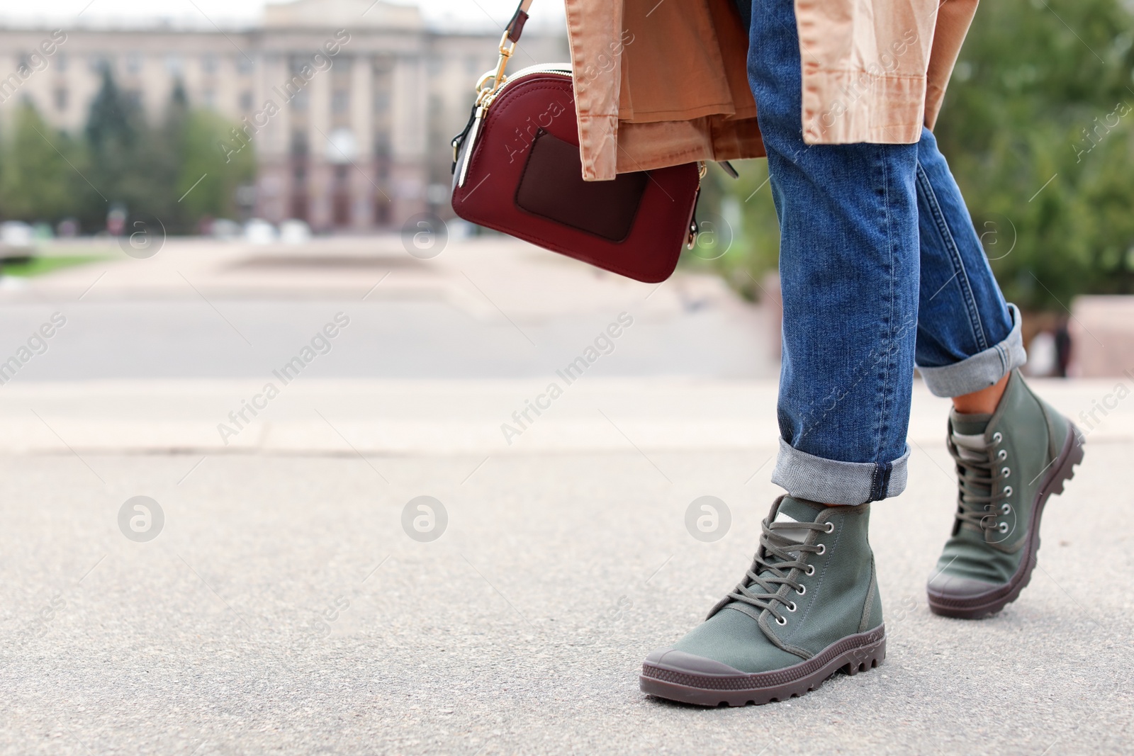 Photo of Young woman in comfortable casual shoes walking on street