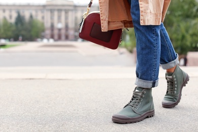 Young woman in comfortable casual shoes walking on street