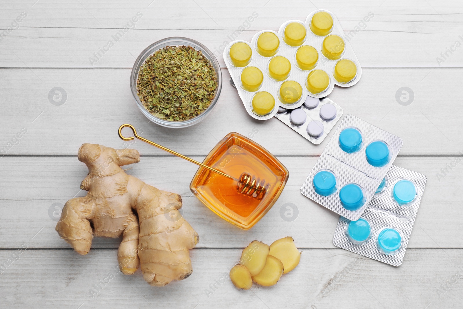 Photo of Cold remedies and pills on white wooden table, flat lay. Cough treatment