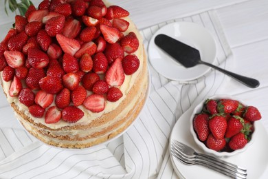 Tasty cake with fresh strawberries served on white table, above view