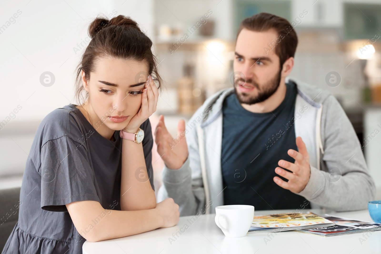 Photo of Young couple having argument at home