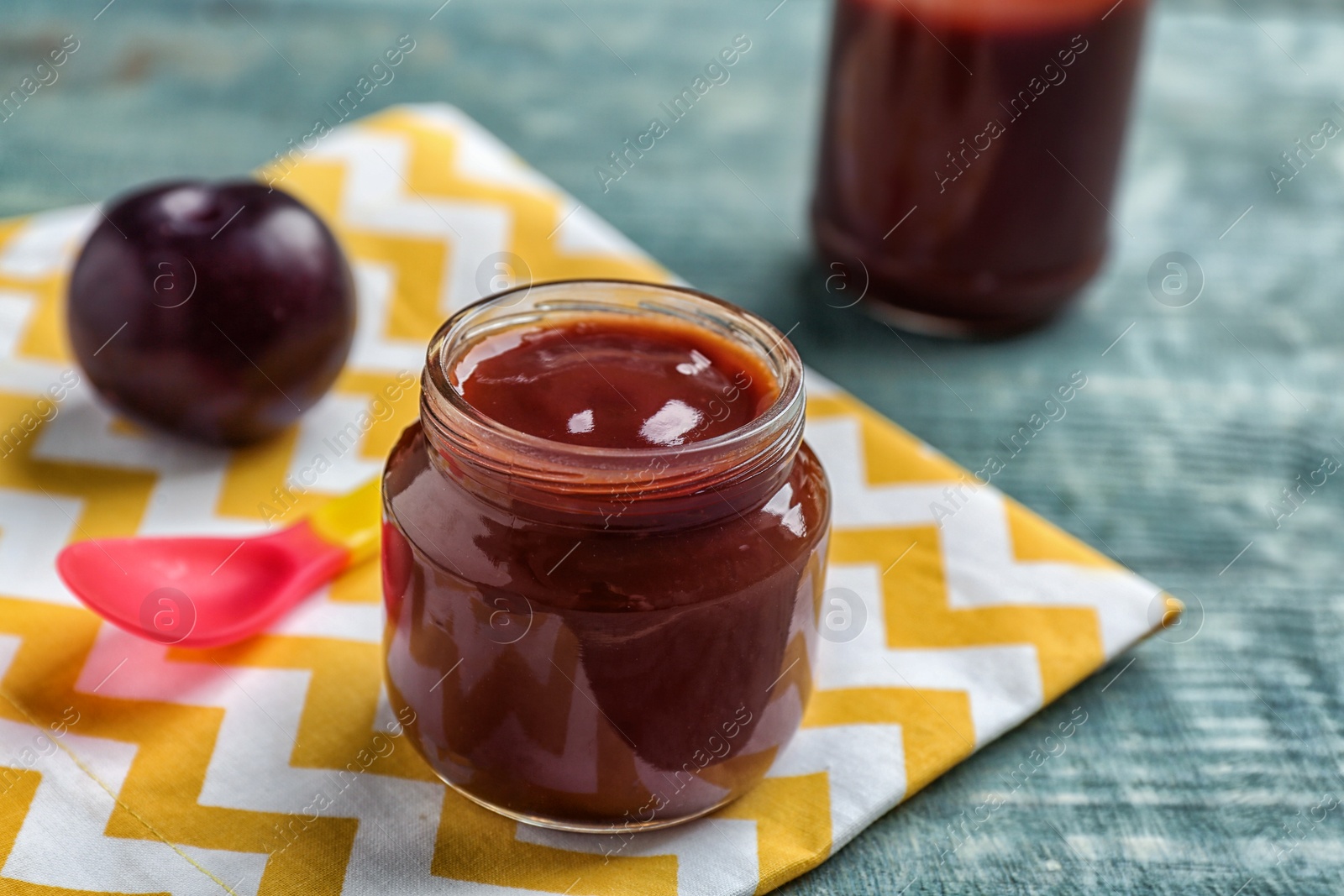 Photo of Jar with healthy baby food on table