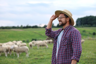 Photo of Portrait of smiling man on pasture at farm. Space for text