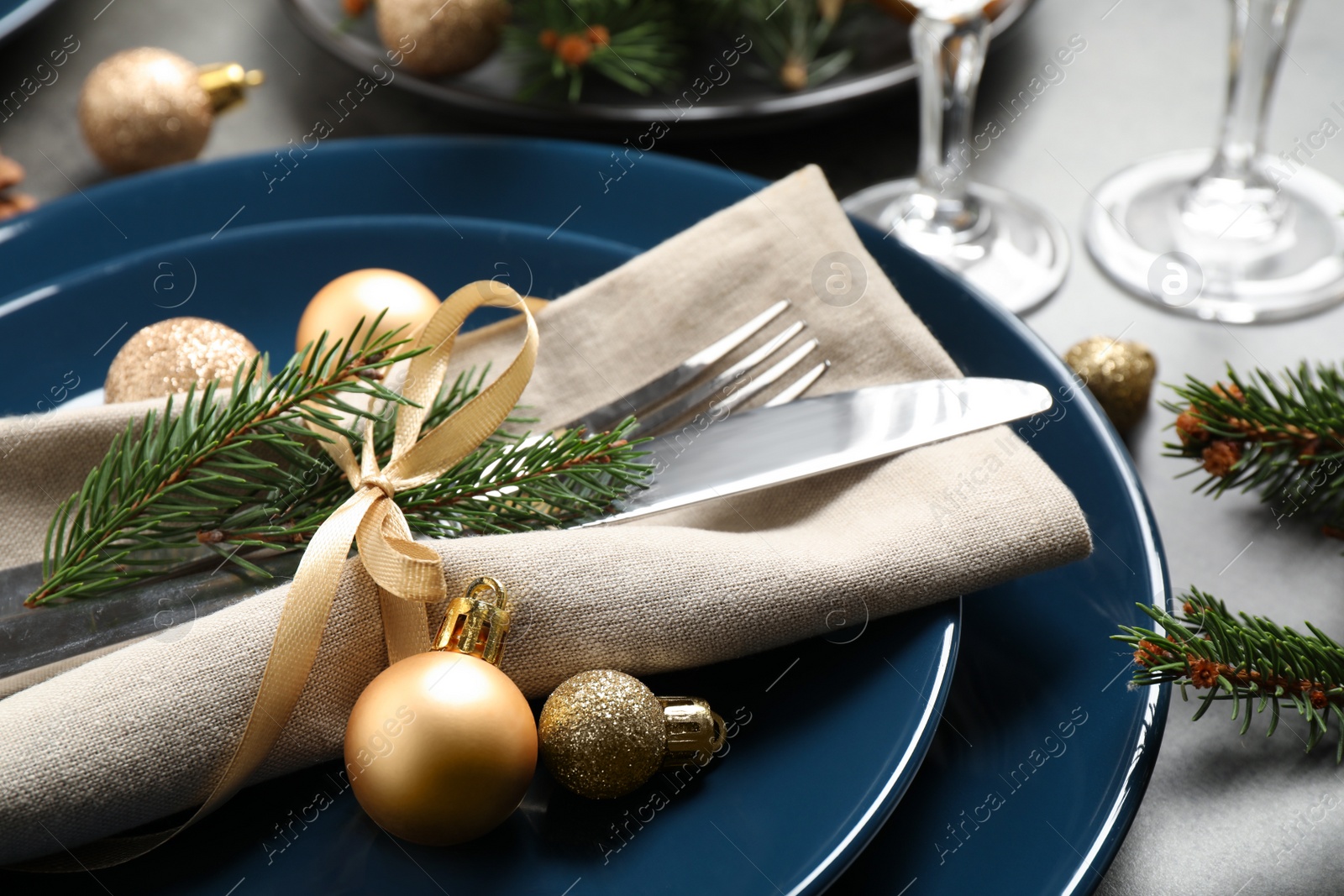 Photo of Festive table setting with beautiful dishware and Christmas decor, closeup