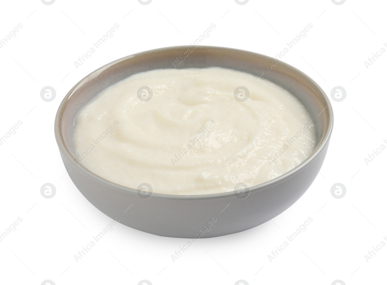 Photo of Bowl with delicious semolina pudding isolated on white