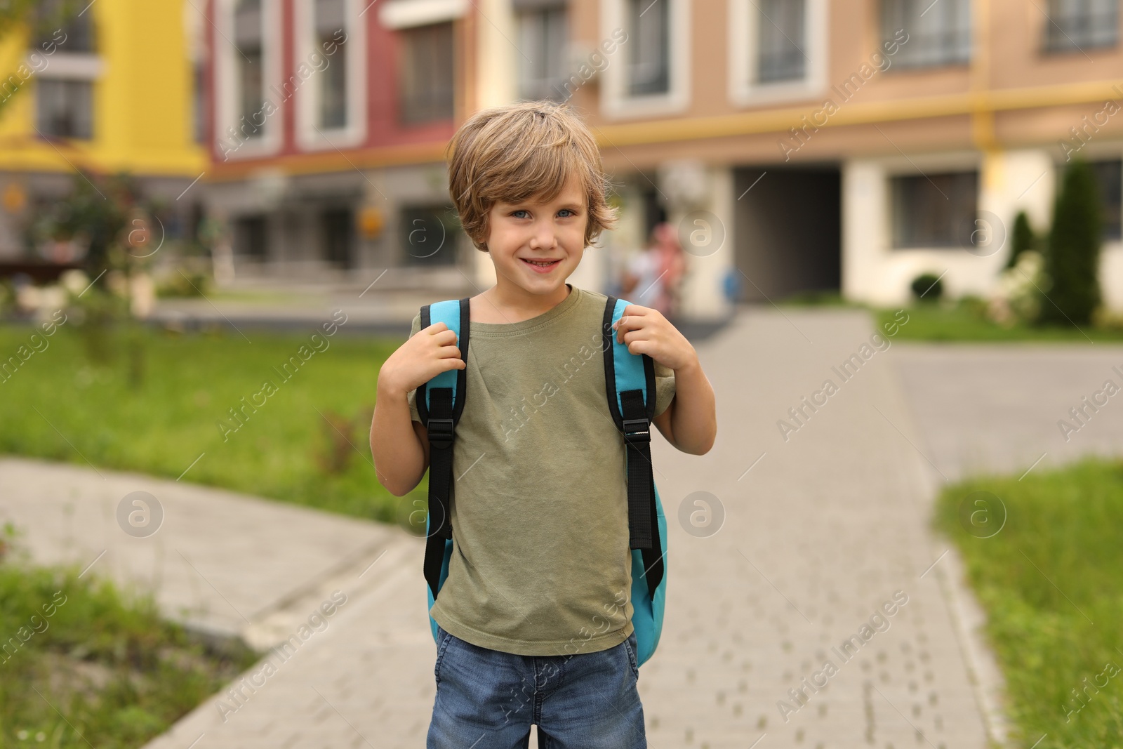 Photo of Cute little boy walking to kindergarten outdoors