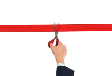 Photo of Man in office suit cutting red ribbon isolated on white, closeup