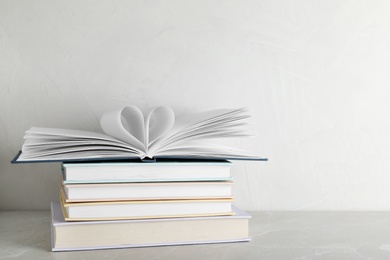 Photo of Stack of hardcover books on table against white background, space for text