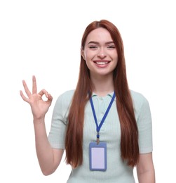 Photo of Happy woman with VIP pass badge showing OK gesture on white background