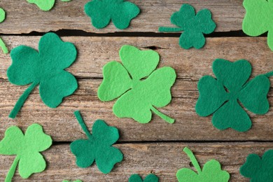 St. Patrick's day. Decorative clover leaves on wooden background, flat lay