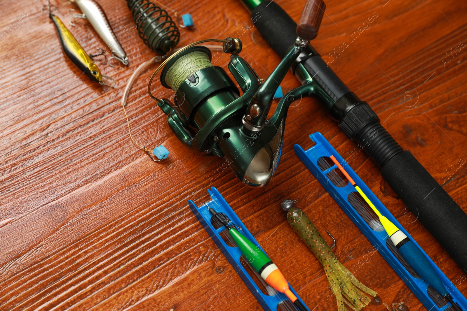 Photo of Fishing tackle on wooden table, space for text