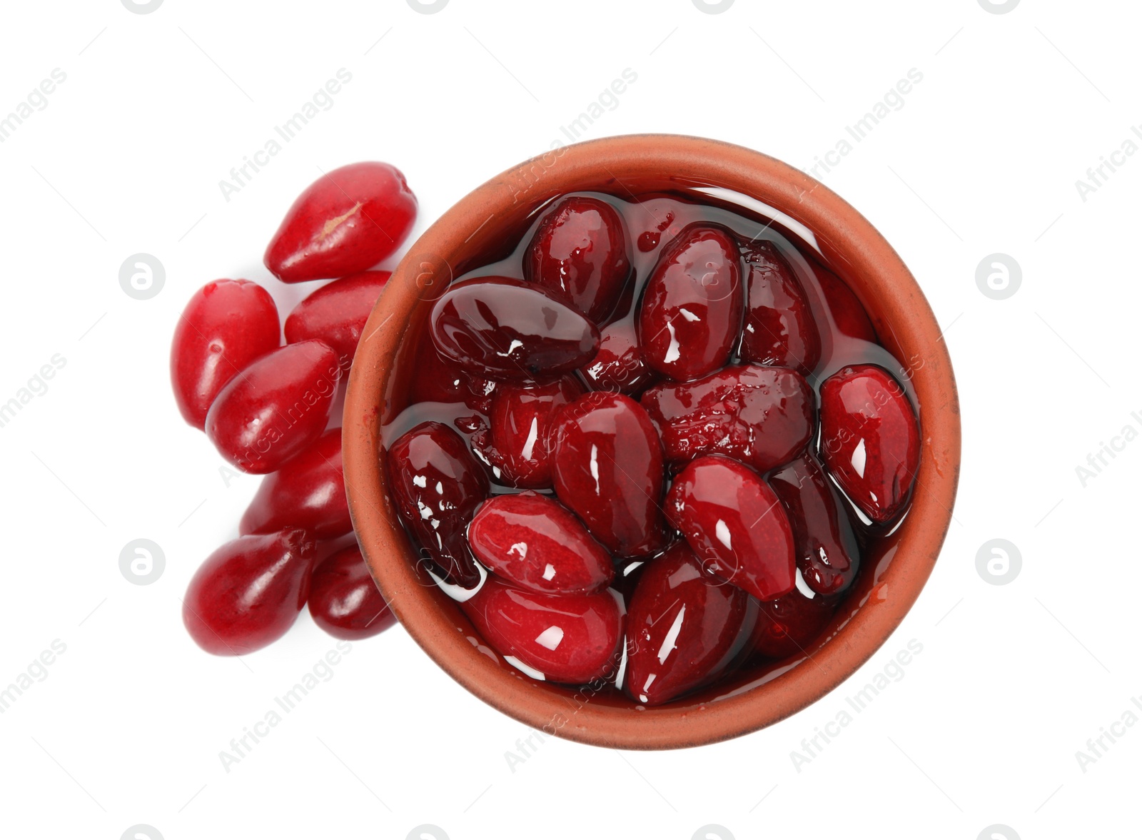 Photo of Delicious dogwood jam with berries and bowl on white background, top view