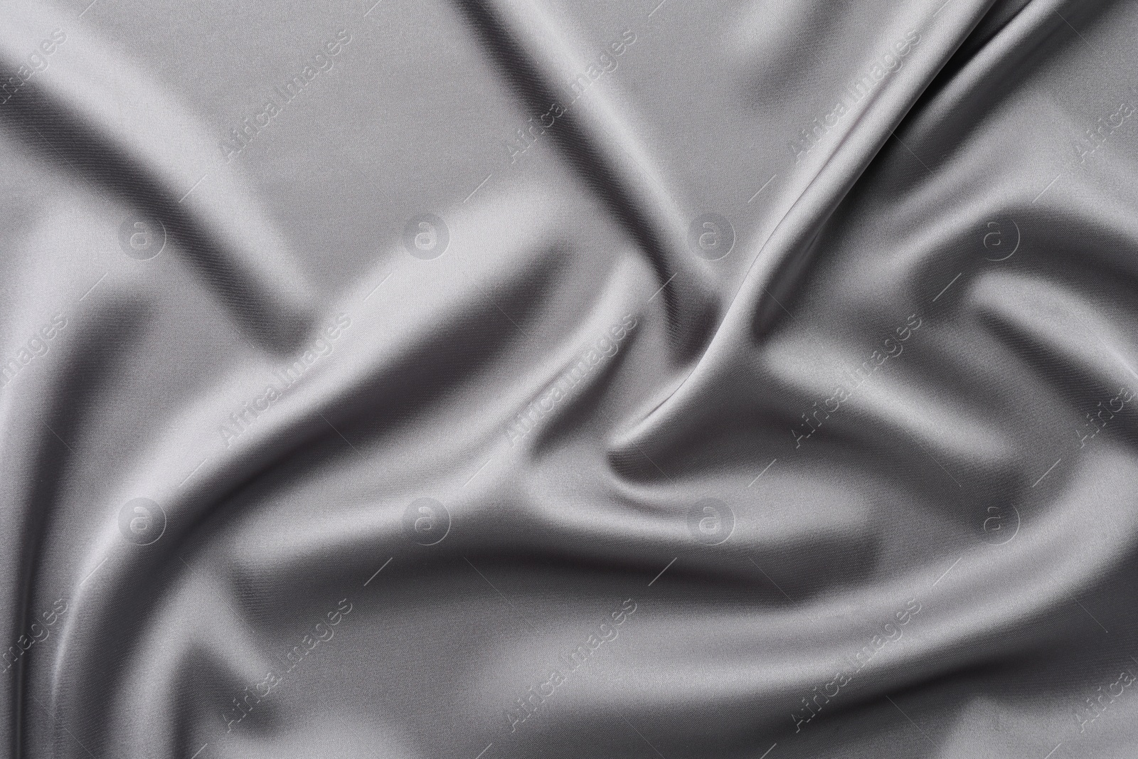 Photo of Texture of beautiful light grey silk fabric as background, closeup