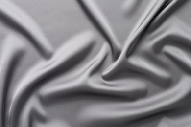 Photo of Texture of beautiful light grey silk fabric as background, closeup