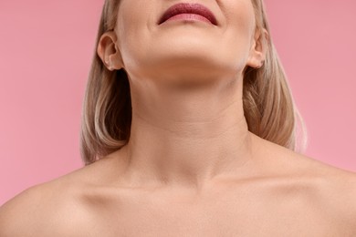 Photo of Woman with healthy skin on pink background, closeup