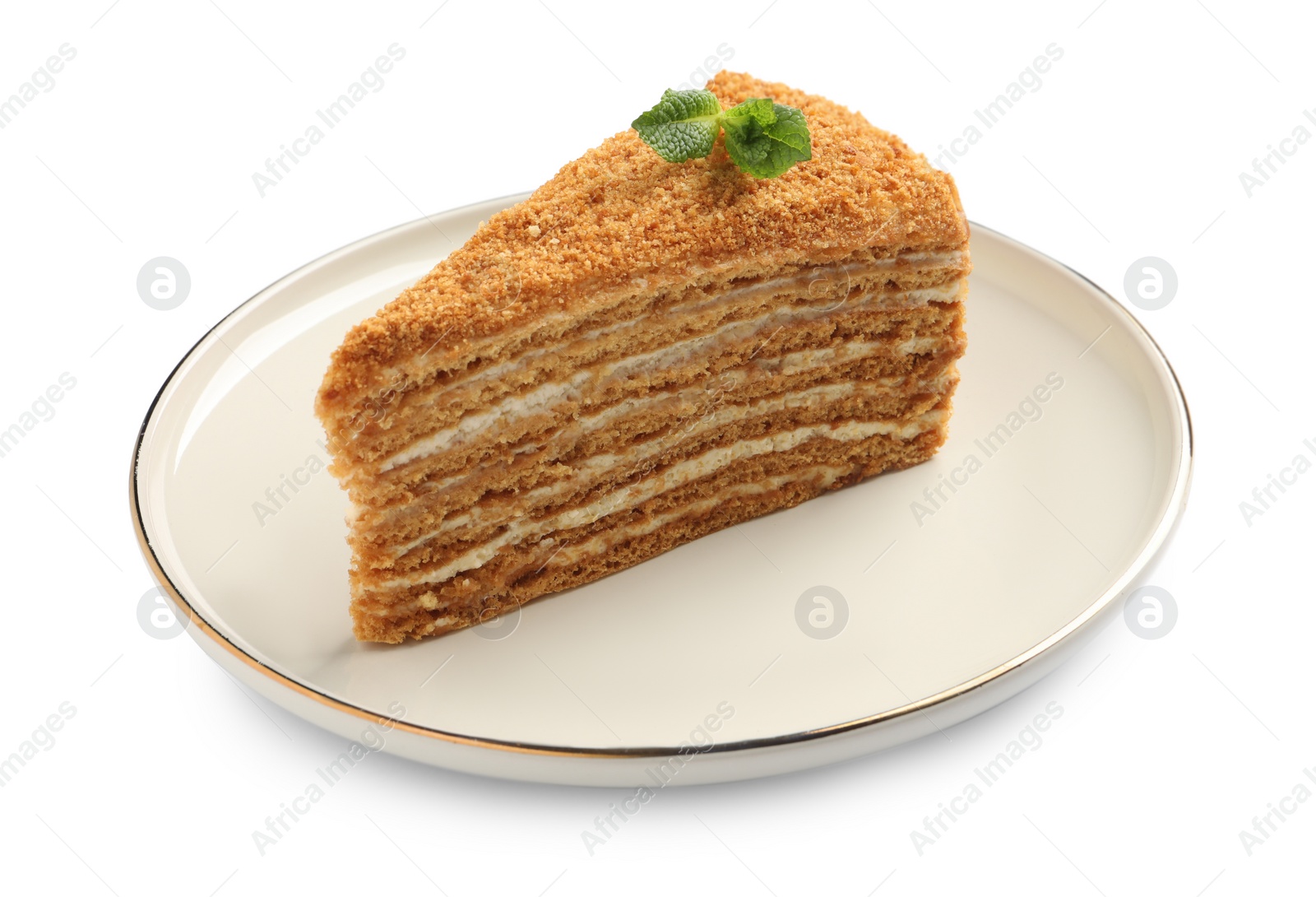 Photo of Slice of delicious honey cake with mint isolated on white