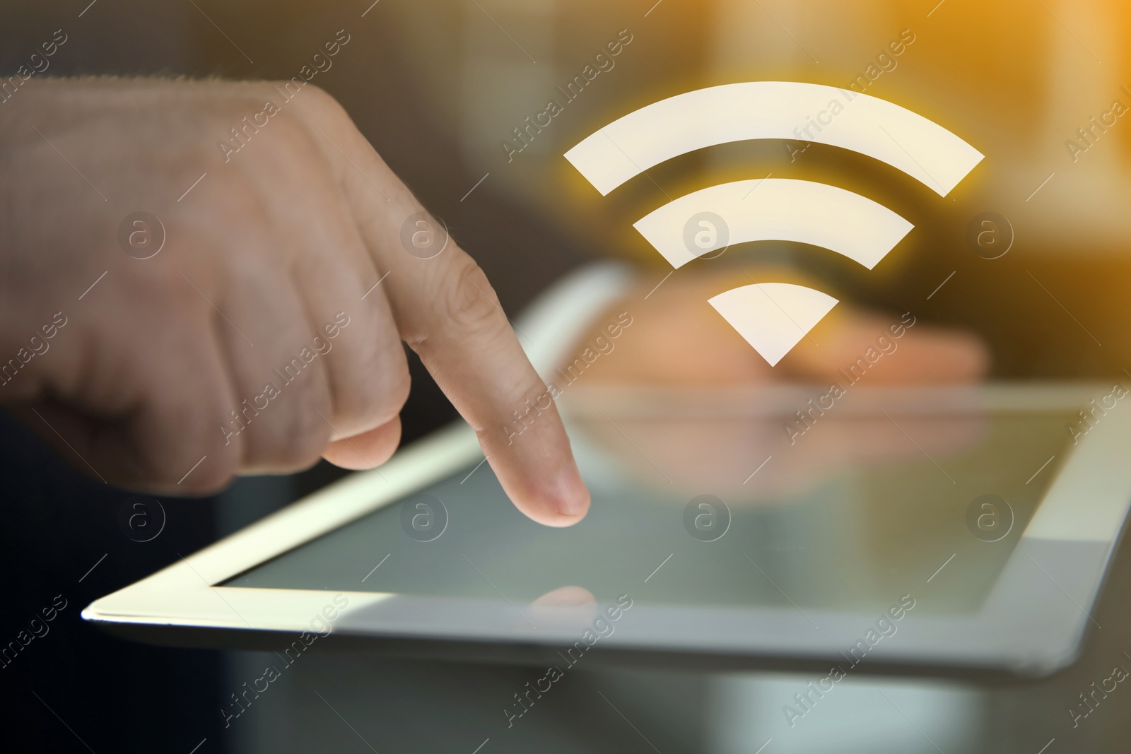 Image of Man using tablet connected to WiFi indoors, closeup