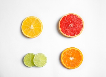 Different citrus fruits on white background, top view