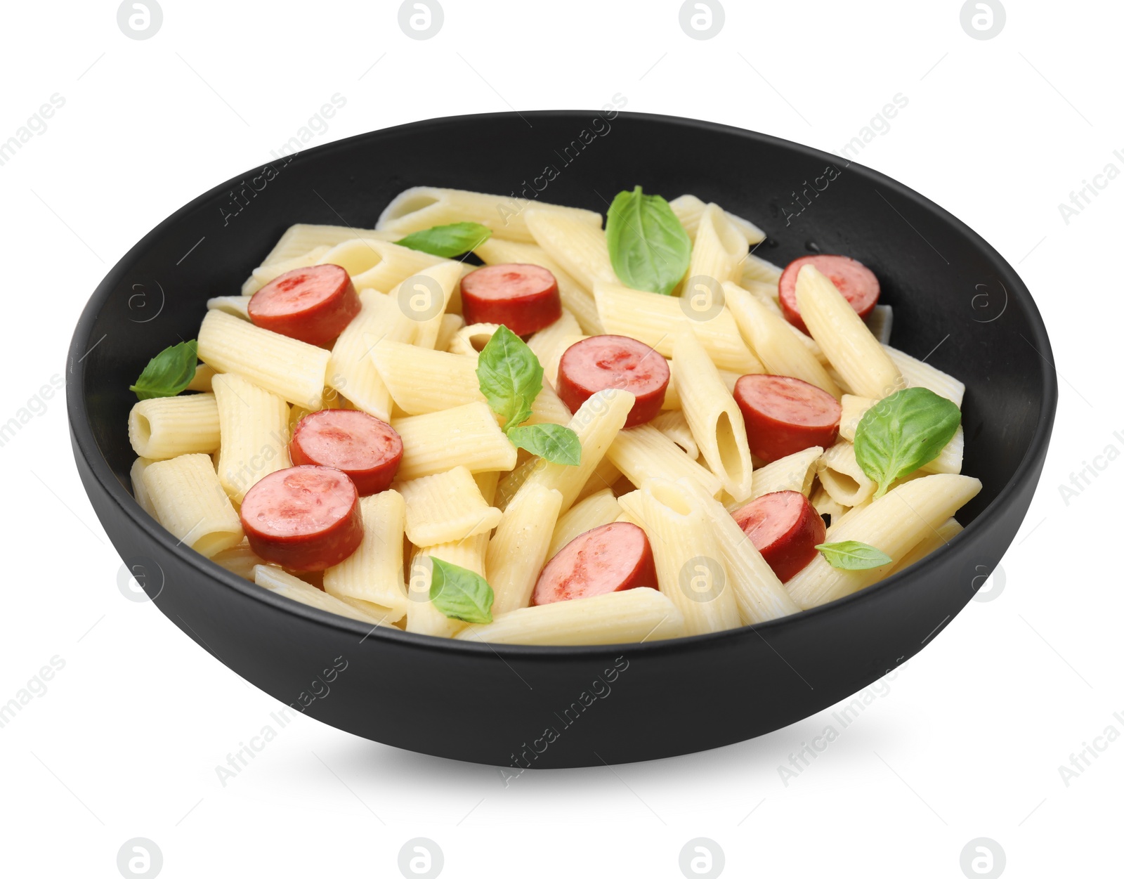 Photo of Tasty pasta with smoked sausage and basil in bowl isolated on white