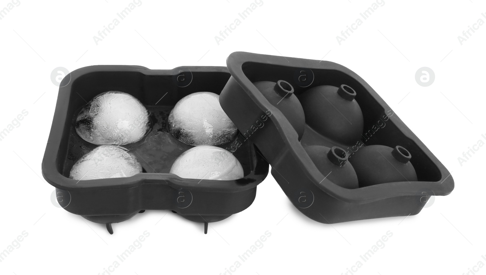 Photo of Frozen ice balls in mold on white background