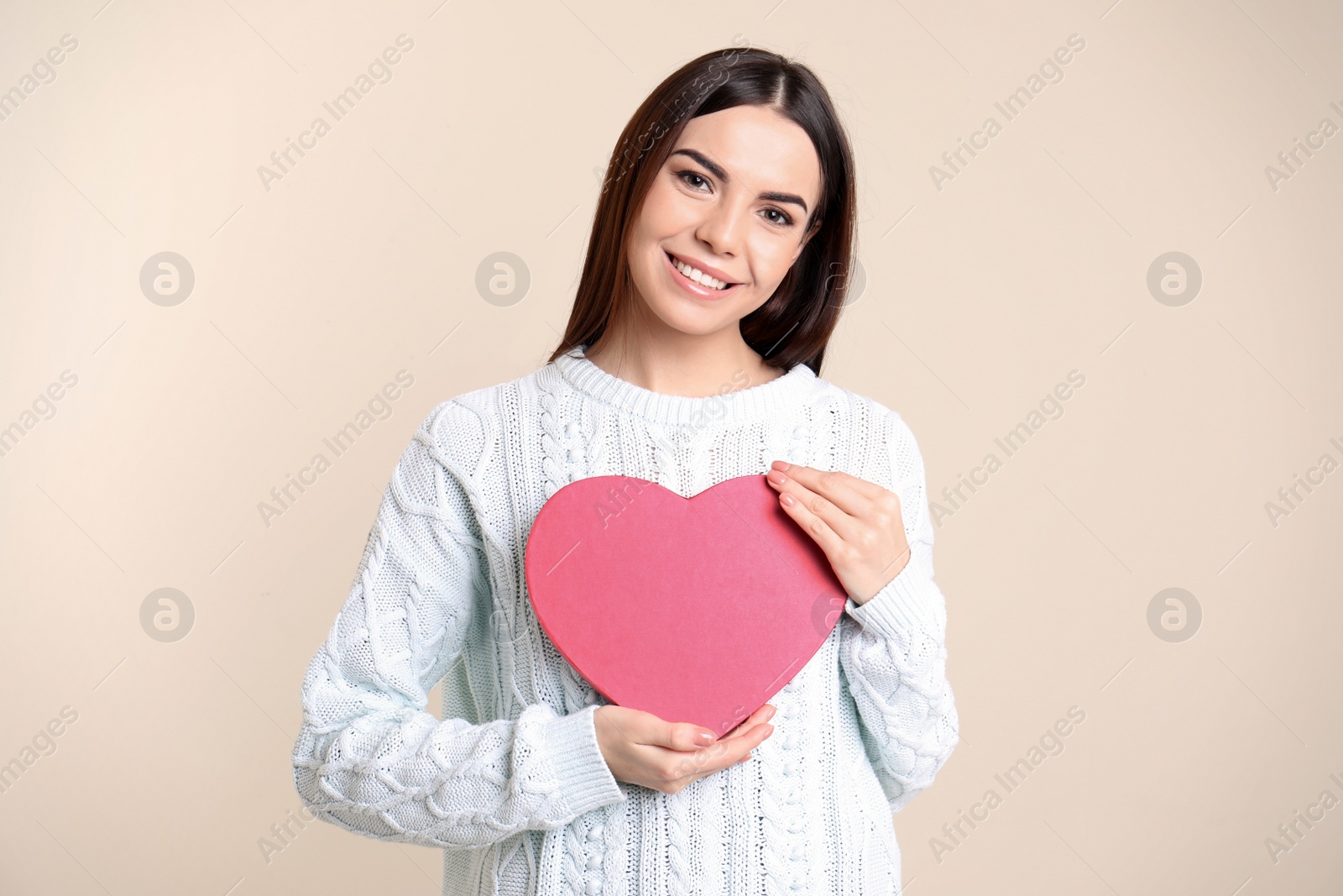 Photo of Portrait of young woman with decorative heart on color background