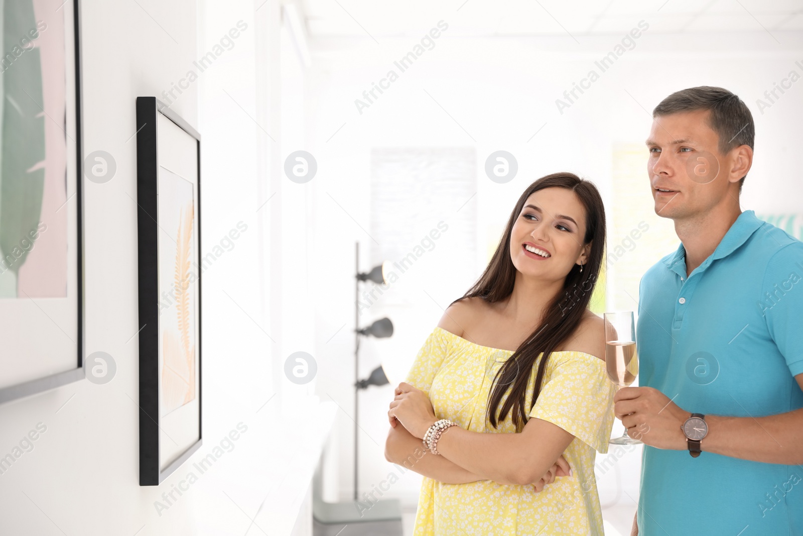 Photo of Young couple at exhibition in art gallery