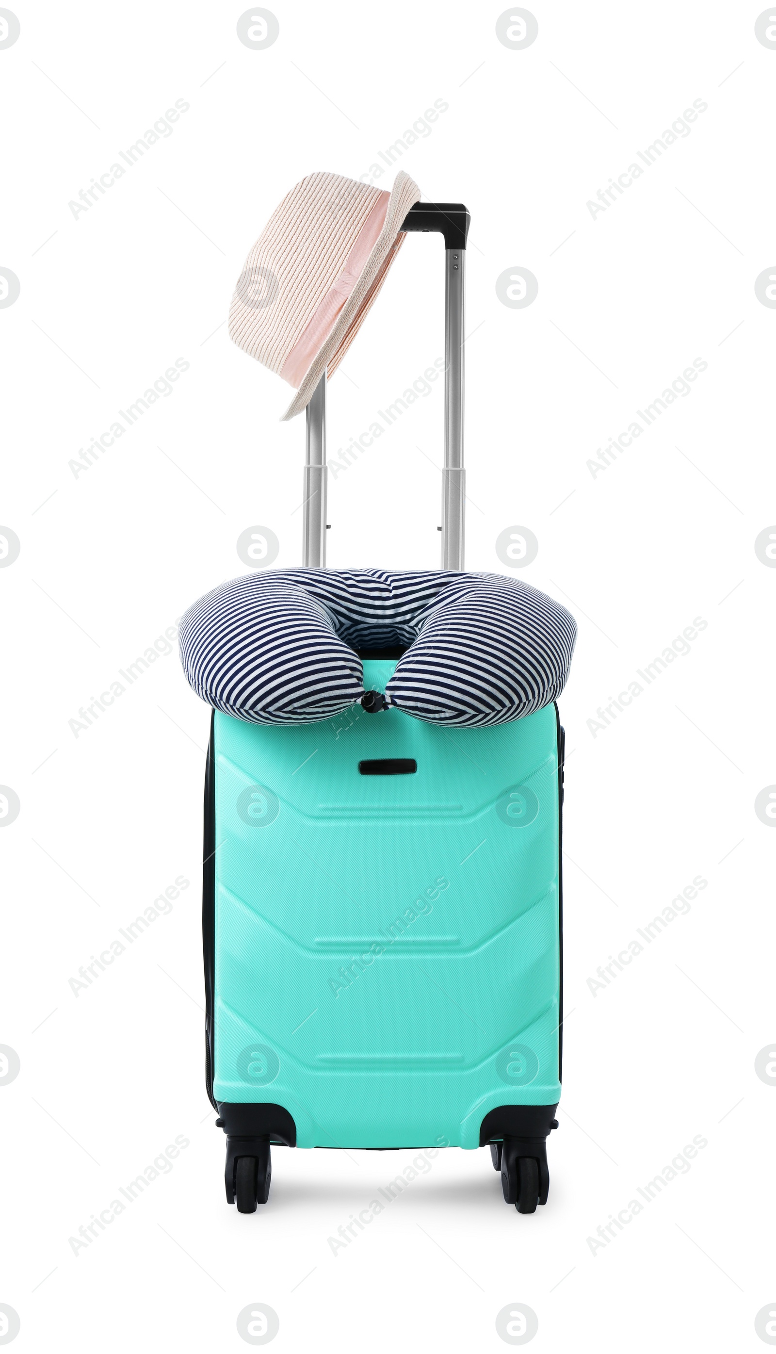 Photo of Soft travel pillow and hat on turquoise suitcase isolated on white