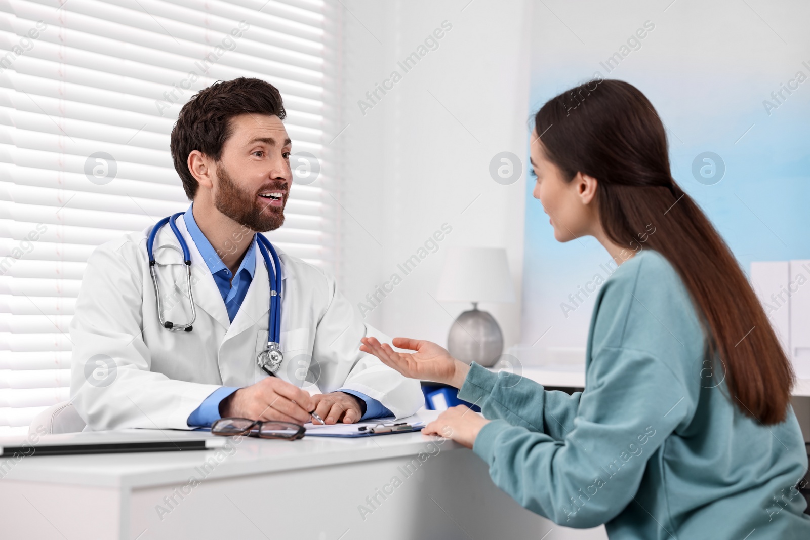 Photo of Doctor consulting patient during appointment in clinic