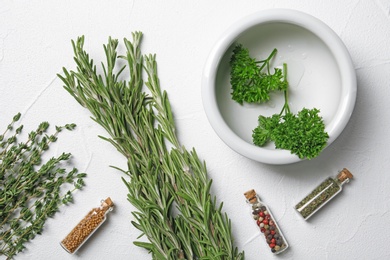 Flat lay composition with rosemary on light background. Aromatic herbs