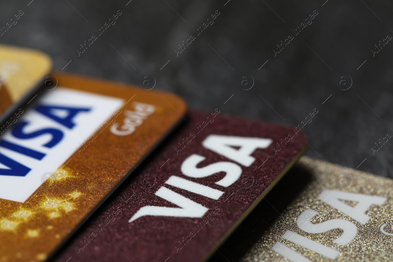 Photo of MYKOLAIV, UKRAINE - FEBRUARY 22, 2022: Visa credit cards on black background, closeup